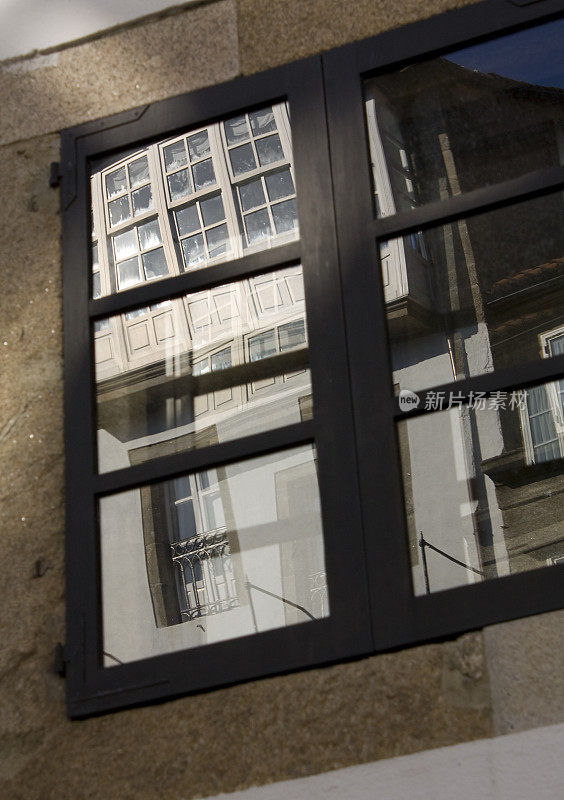 Closed window , stone house, galería facade reflected